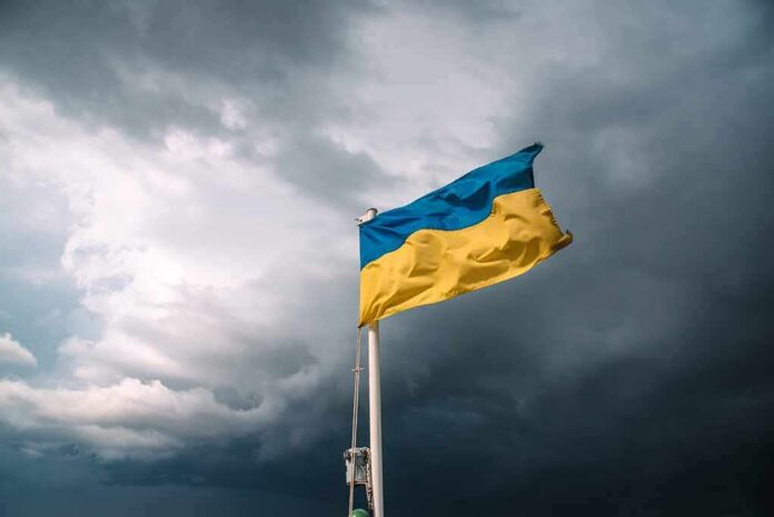 Ukrainian flag waving against a stormy sky