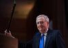 Proof Or Propaganda? CNN Meltdown Over McConnell Call A man in a suit holding a gavel at a podium