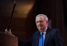 Proof Or Propaganda? CNN Meltdown Over McConnell Call A man in a suit holding a gavel at a podium