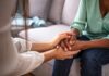 Courts Gut Michigan’s Therapy Gag Two people holding hands on a couch