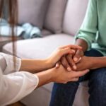 Courts Gut Michigan’s Therapy Gag Two people holding hands on a couch
