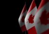 Allied Twist: Canada Snubs U.S. Subs Canadian flags with maple leaf on dark background