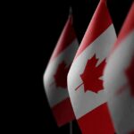 Allied Twist: Canada Snubs U.S. Subs Canadian flags with maple leaf on dark background