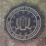 Helicopters Swarm—FBI Storms LA Luxe Towers FBI seal mounted on a stone wall