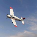 Single-engine airplane banking in a clear sky