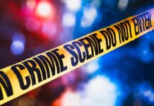 Boyfriend Blames Demon — Jeep Tells Different Story yellow crime scene tape with blurred police lights