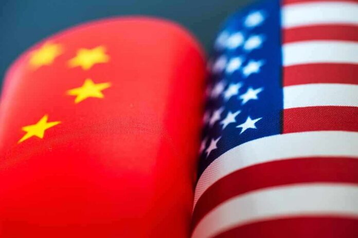 shutterstock_1093304267 Chinese and American flags side by side