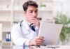 Doctor reviewing a file at a desk