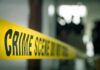 Preventable Death Sparks Sanctuary Uproar crime scene tape in a blurred indoor setting