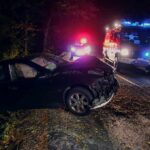 Tesla Crash Turns Pool Into Chaos Crashed car on a dark roadside with emergency vehicles