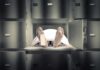 Body on morgue tray with toe tag and sheet