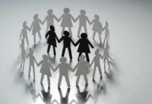 Paper cutout people linked in a circle
