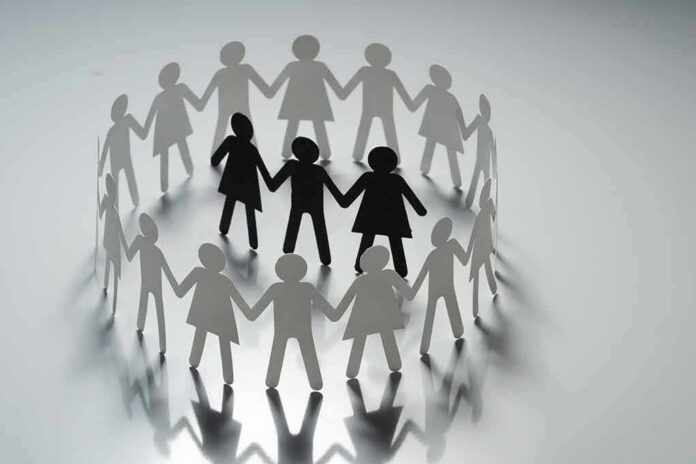 Paper cutout people linked in a circle