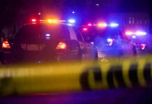 Speeding Wrong-Way – DA Drops Hammer Police cars with flashing lights behind yellow caution tape at night