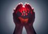 Hands cupping a glowing fetal silhouette
