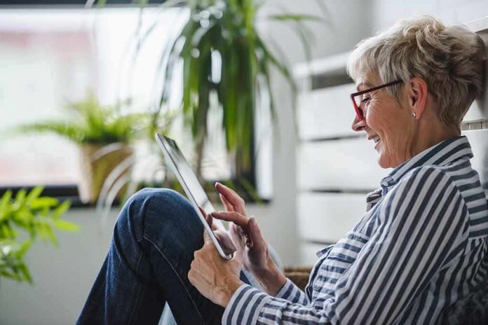 shutterstock_1492696199 Older woman using a tablet at home