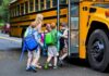 Children boarding a yellow school bus