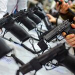 Army’s Bold Switch Ignites Pistol Revolution Handguns on display at a store counter