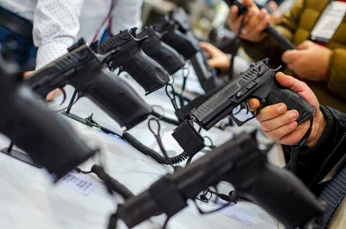 shutterstock_1538332343 Handguns on display at a store counter