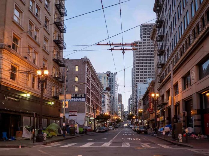 shutterstock_1725275425 Urban street lined with mid-rise buildings at dusk