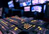 broadcast control room mixing console with illuminated buttons