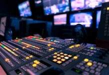 broadcast control room mixing console with illuminated buttons