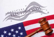 Councilman Caught—Absentee Ballot Plot Exposed Gavel on U.S. flag beside official election mail envelope