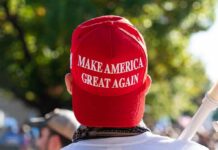 MAGA Muzzle? Bartiromo Out After Leak person wearing a red baseball cap at an outdoor gathering