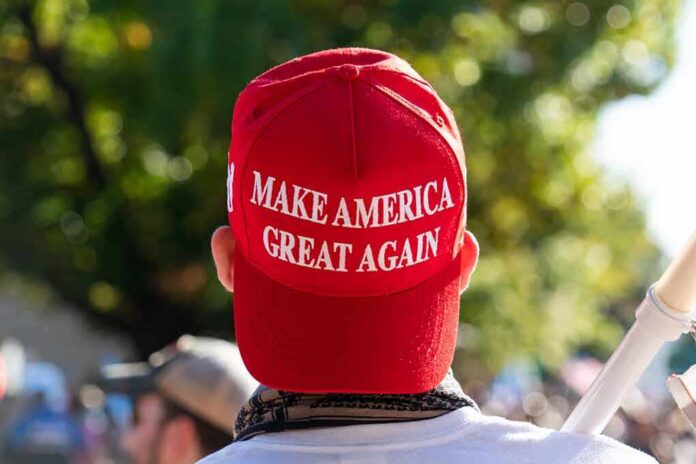 person wearing a red baseball cap at an outdoor gathering