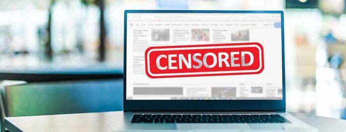 Laptop screen with censored banner displayed
