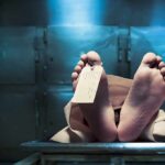 Coffin Abandoned—Red Cross Teams Ambushed Mid-Burial Corpse on a morgue table with toe tag