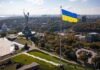 Ukraine Air-Defense Deal Triggers Review Ukrainian flag flying over Kyiv skyline with Motherland Monument