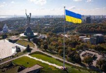 Ukraine Air-Defense Deal Triggers Review Ukrainian flag flying over Kyiv skyline with Motherland Monument