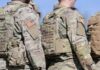 U.S. soldiers in camouflage uniforms with tactical vests