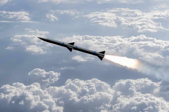 Rocket flying above clouds with bright exhaust plume