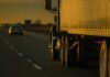 Newlyweds Dead – DMV Defends Undocumented Trucker Semi-truck trailer driving on highway at sunset