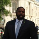 Red-State Formula – Crowd ERUPTS As Donalds Dares Dallas Man in a suit speaking outside a neoclassical government building