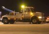 Impound Chaos – Towing Fiasco Slams Returning Sailors Tow truck with flashing lights parked at night