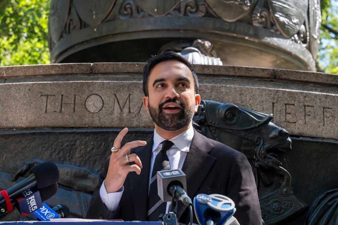 Zohran Mamdani speaking at an outdoor press conference