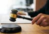 Immigration Court Turmoil: Bond Rulings Flipped Judge's hand holding a gavel over a sound block