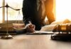 Wrong Matthew – Court Blunder Sparks Doxxing Nightmare Lawyer writing at desk with scales and gavel
