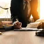 Wrong Matthew – Court Blunder Sparks Doxxing Nightmare Lawyer writing at desk with scales and gavel