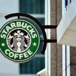 Coffee Giant’s Sudden Cutback – Turnaround or Trouble Brewing? Starbucks coffee shop sign on building exterior