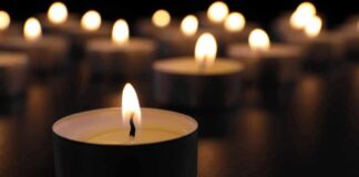 Tealight candle burning with soft glow