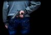Election Site Chaos: Rep. Draws Weapon person holding a handgun behind their back