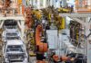 China Squeeze Triggers Defense Pivot – Carmakers Go Military Industrial robots assemble car bodies on an automotive production line