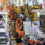 China Squeeze Triggers Defense Pivot – Carmakers Go Military Industrial robots assemble car bodies on an automotive production line