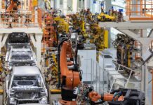 China Squeeze Triggers Defense Pivot – Carmakers Go Military Industrial robots assemble car bodies on an automotive production line