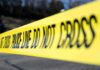 Deliberate MP Hit? Counterterror Team Swarms Yellow police tape stretched across an outdoor scene