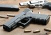 Security Meltdown: How Did A Glock Beat The Screeners? Handguns and ammunition on a wooden surface